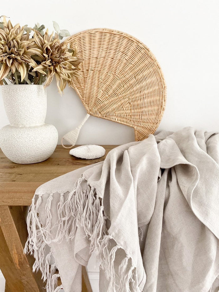 A beautifully handwoven quality rattan fan shaped wall Hanging generously sized and perfect for filling that empty wall space. Unlike common palm leaf variations typically used for their versatile & bendable body, this piece has been made with furniture grade rattan, is not flexible & is specifically designed for use as a wall hanging or styling accessory.